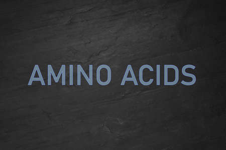 Text Amino Acids on black slate surfaceの写真素材