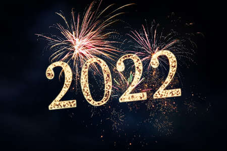 Happy New Year greeting card design. 2022 silhouettes made of fireworks
