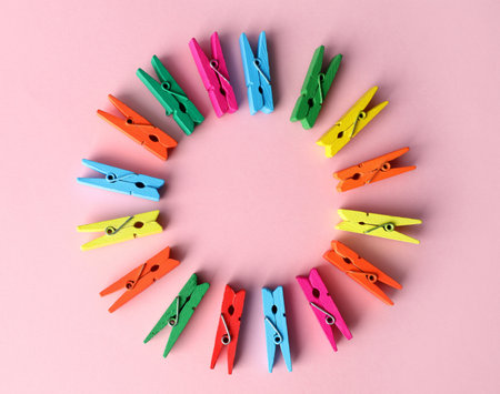 Frame of many different colorful clothes pins on pink background, flat lay. Diversity conceptの写真素材