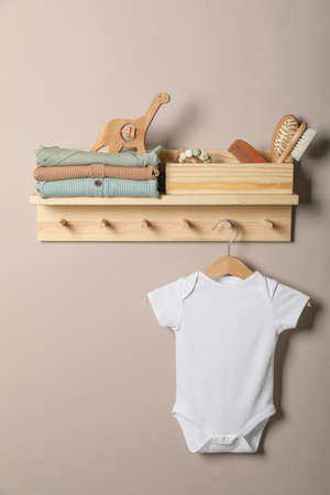 Baby clothes, toys and accessories on wooden rackの写真素材