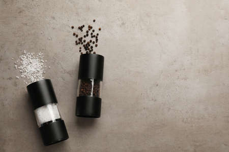 Salt and pepper shakers on light table, flat lay. Space for textの写真素材