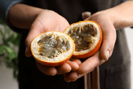 Woman with halves of granadilla, closeup. Exotic fruitの写真素材