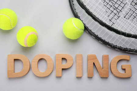 Word Doping, tennis rackets and balls on light gray background, flat layの写真素材