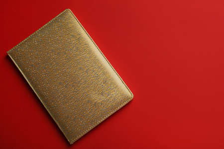 New stylish planner with leather cover on red background, top view. Space for textの写真素材