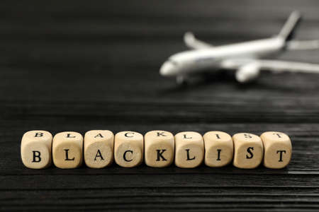 Cubes with word Blacklist on black wooden table, closeupの写真素材