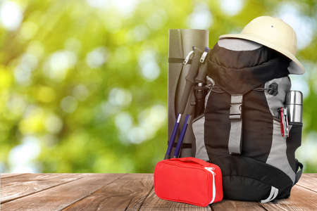 Camping equipment for tourist on wooden surface outdoorsの写真素材