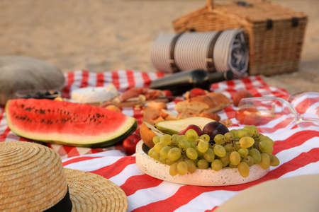 Different tasty snacks on picnic blanket outdoorsの写真素材