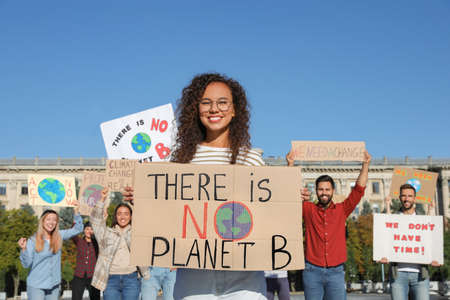 Group of people with posters protesting against climate change outdoorsの写真素材