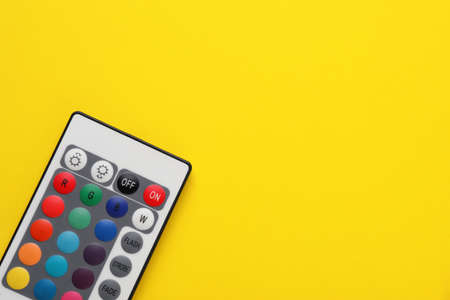 Remote control on yellow background, top view. Space for textの写真素材