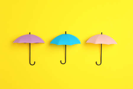 Bright toy umbrellas on yellow background, flat layの写真素材