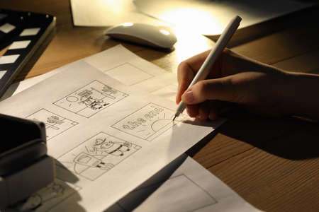 Woman drawing cartoon sketches at workplace, closeup. Pre-production processの写真素材