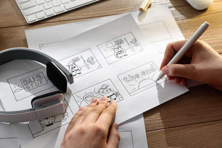 Woman drawing cartoon sketches at workplace, closeup. Pre-production processの写真素材