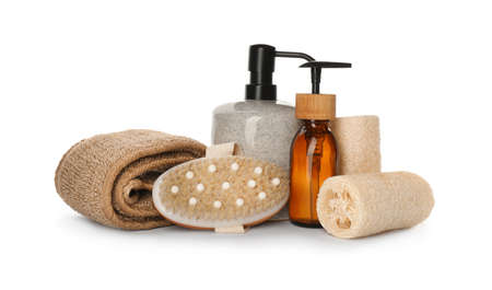 Set of toiletries with natural loofah sponges on white background