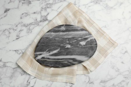 Kitchen towel and stone board on white marble table, top viewの写真素材
