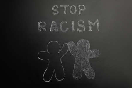 Chalked inscription Stop Racism and people figures on blackboardの写真素材