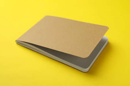New stylish kraft planner on yellow background