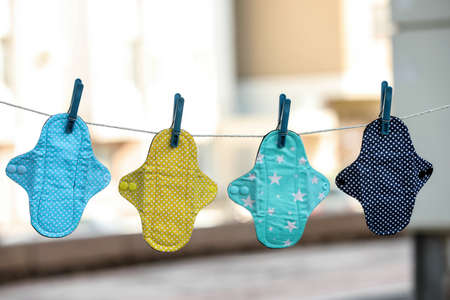 Many different menstrual cloth pads hanging on rope outdoorsの写真素材