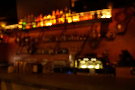 Blurred view of stylish modern bar interior with bokeh effect