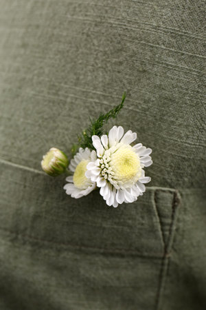 Woman wearing shirt with flowers in pocket, closeup