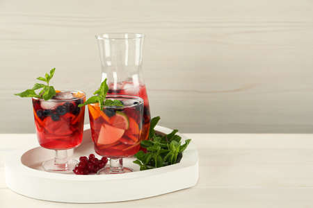 Delicious Red Sangria and ingredients on white wooden table, space for textの写真素材