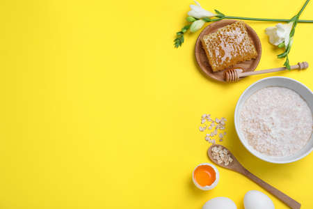 Homemade hair mask and ingredients on yellow background, flat lay. Space for textの写真素材
