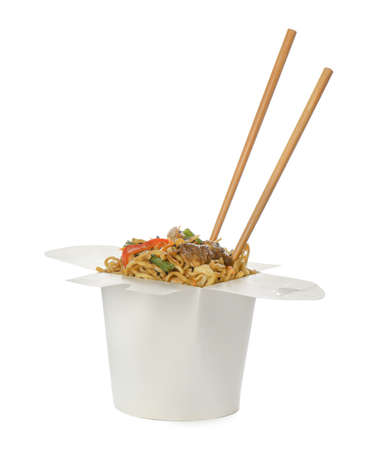 Box of wok noodles with vegetables, meat and chopsticks isolated on whiteの写真素材