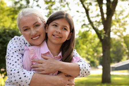 Mature woman with her little granddaughter in park