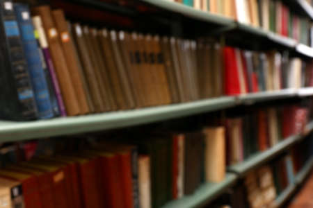 Blurred view of books on shelves in libraryの写真素材