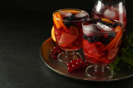 Delicious Red Sangria and ingredients on black table, space for textの写真素材