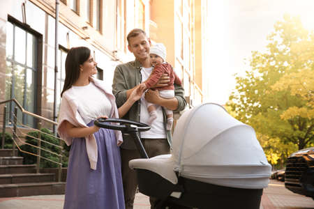 Happy parents walking with their baby outdoorsの写真素材