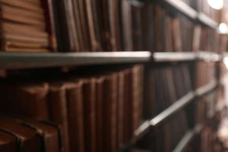 Blurred view of books on shelves in libraryの写真素材