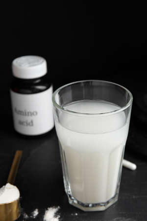 Amino acid shake and powder on black backgroundの写真素材