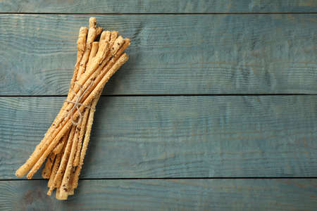 Delicious grissini sticks on wooden table, top view. Space for textの写真素材