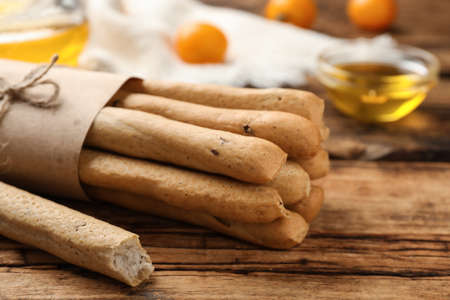 Delicious grissini sticks on wooden table, closeupの写真素材