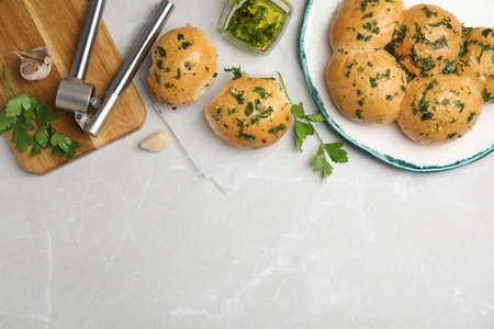 Traditional Ukrainian bread (Pampushky) with garlic on light gray marble table, flat lay. Space for textの写真素材