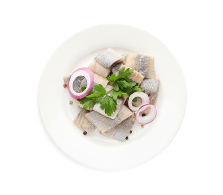 Plate with delicious salted herring slices, onion rings, peppercorns and parsley isolated on white, top viewの写真素材