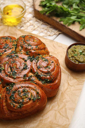 Traditional pampushka rolls with garlic and herbs on table, closeupの写真素材