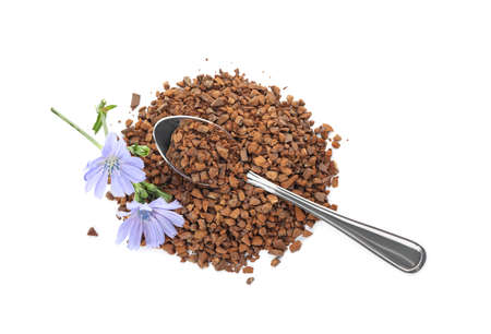 Pile of chicory granules and flowers on white background, top viewの写真素材