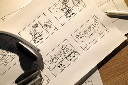 Storyboards with cartoon sketches at workplace, flat lay. Pre-production processの写真素材