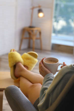 Woman with cup of aromatic coffee relaxing at home, closeupの写真素材