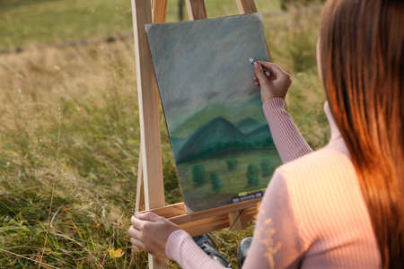 Woman drawing landscape with soft pastels outdoors, closeupの写真素材