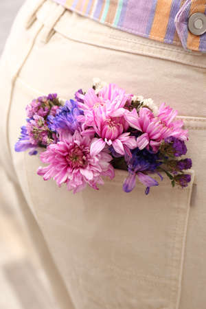 Woman wearing jeans with flowers in pocket, closeupの写真素材