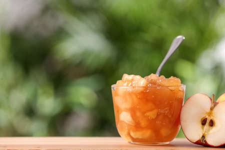 Delicious apple jam and fresh fruit on wooden table. Space for textの写真素材
