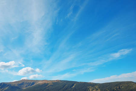 Picturesque view of sky with clouds over mountainsの写真素材