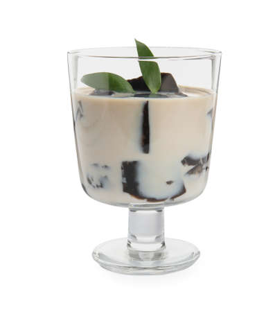 Glass of milk with grass jelly and green leaves isolated on whiteの写真素材