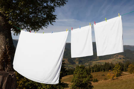 Laundry with clothes pins on line outdoorsの写真素材