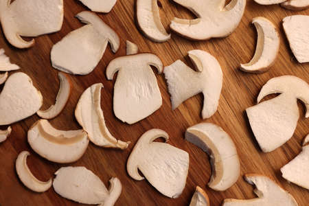 Slices of mushrooms on wooden board prepared for natural dehydration, closeupの写真素材
