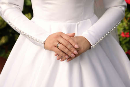 Bride wearing beautiful engagement ring and wedding dress, closeupの写真素材