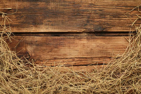 Dried hay on wooden background, flat lay. Space for textの写真素材