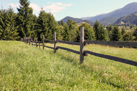 Beautiful view of mountain countryside with wooden fenceの写真素材